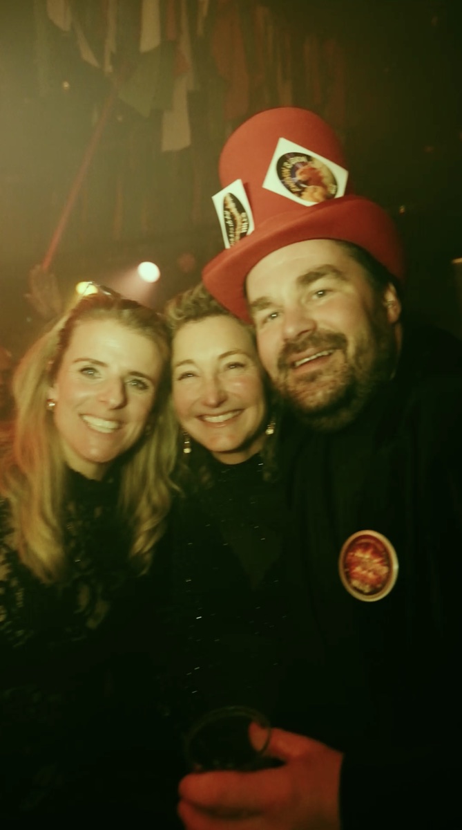 Drie lachende vrienden op de dansvloer